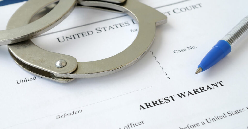 District Court Arrest Warrant Court Papers with Handcuffs